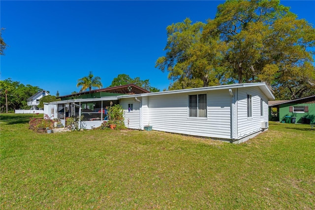 191 Howes St, Oak Hill, FL 32759 - view of front of house featuring a front yard and a sunroom