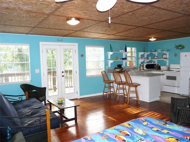 191 Howes St, Oak Hill, FL 32759 - living room with french doors, baseboards, and dark wood finished floors