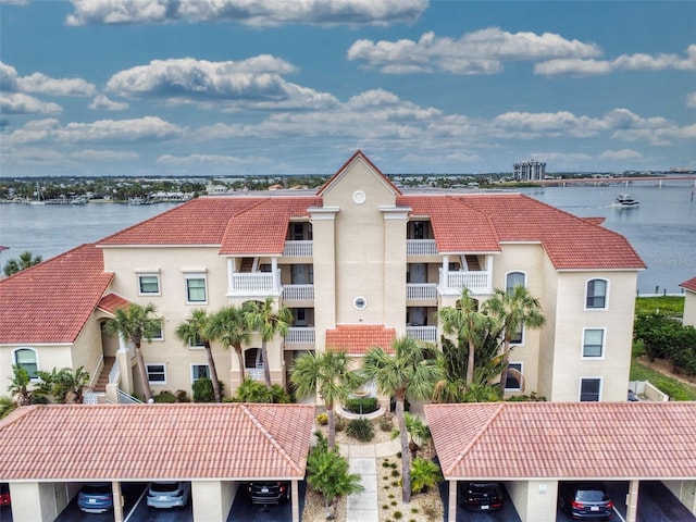 438 Bouchelle Dr Unit 104, New Smyrna Beach, FL 32169 - view of building exterior with covered parking and a water view