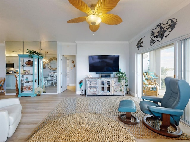 438 Bouchelle Dr Unit 104, New Smyrna Beach, FL 32169 - living room with ceiling fan with notable chandelier, crown molding, baseboards, and wood finished floors