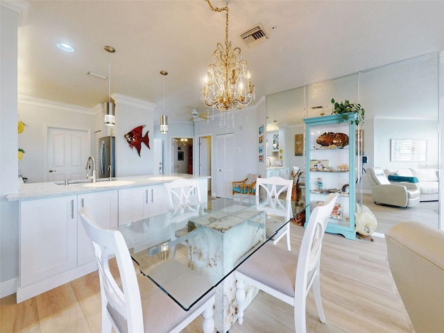 438 Bouchelle Dr Unit 104, New Smyrna Beach, FL 32169 - dining space with recessed lighting, ornamental molding, light wood-style floors, visible vents, and a notable chandelier