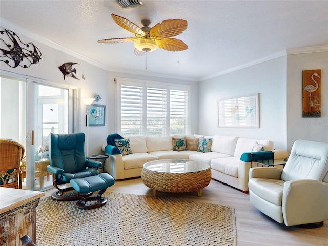 438 Bouchelle Dr Unit 104, New Smyrna Beach, FL 32169 - living room featuring crown molding, light wood-style flooring, and ceiling fan