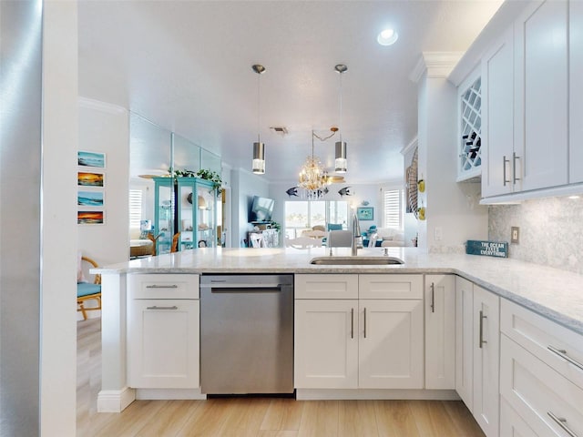 438 Bouchelle Dr Unit 104, New Smyrna Beach, FL 32169 - kitchen with a sink, a peninsula, stainless steel dishwasher, visible vents, and ornamental molding