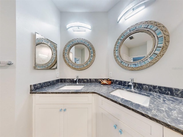 438 Bouchelle Dr Unit 104, New Smyrna Beach, FL 32169 - bathroom featuring double vanity, visible vents, and a sink