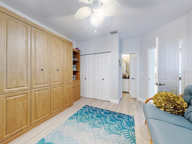 438 Bouchelle Dr Unit 104, New Smyrna Beach, FL 32169 - living area with baseboards, visible vents, light wood-style floors, and ceiling fan