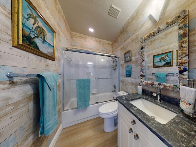438 Bouchelle Dr Unit 104, New Smyrna Beach, FL 32169 - full bathroom featuring wood finished floors, a textured ceiling, wooden walls, and visible vents