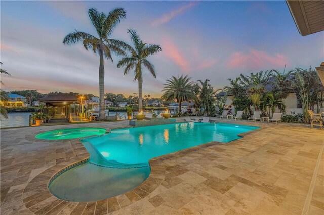 1212 Commodore Dr, New Smyrna Beach, FL 32168 - pool at dusk featuring a gazebo, a patio area, and a pool with connected hot tub