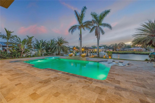 1212 Commodore Dr, New Smyrna Beach, FL 32168 - view of swimming pool featuring a jacuzzi, a water view, and a patio area