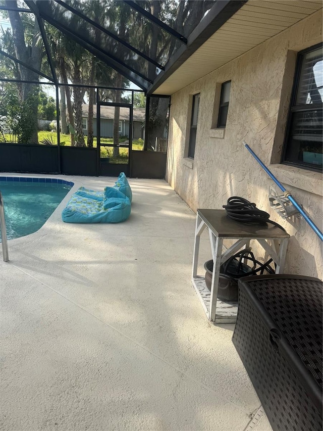pool featuring a lanai and a patio area