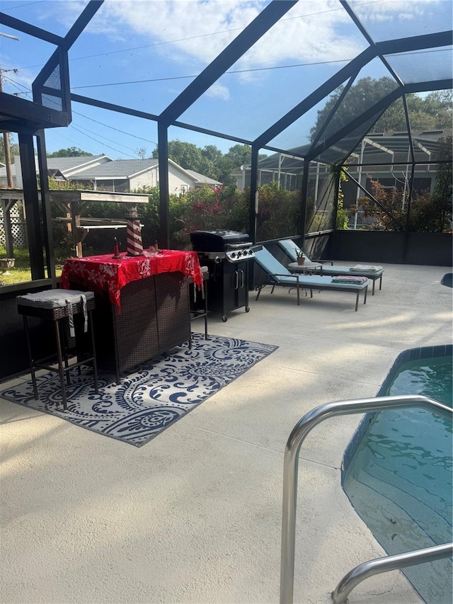 pool with a lanai, outdoor lounge area, a patio area, and grilling area