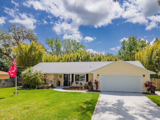 single story home with concrete driveway, an attached garage, a front yard, fence, and a shingled roof