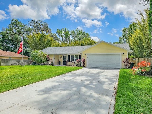 single story home with a front lawn, fence, a garage, and driveway