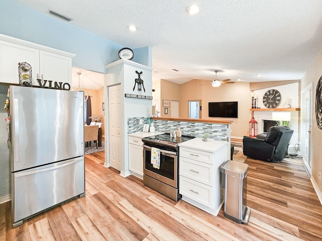 kitchen with ceiling fan, white cabinetry, visible vents, appliances with stainless steel finishes, and light countertops