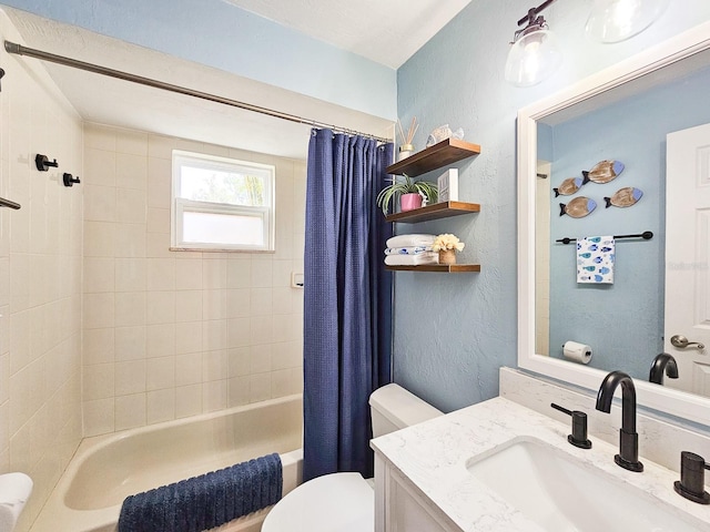 full bathroom with a textured wall, shower / bath combo with shower curtain, vanity, and toilet