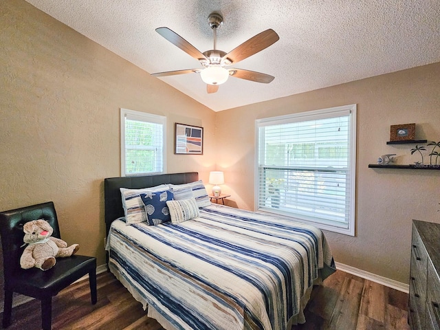 bedroom featuring baseboards, vaulted ceiling, a textured wall, a textured ceiling, and dark wood-type flooring