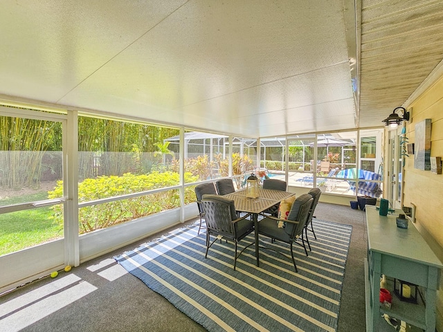 sunroom / solarium with outdoor dining area