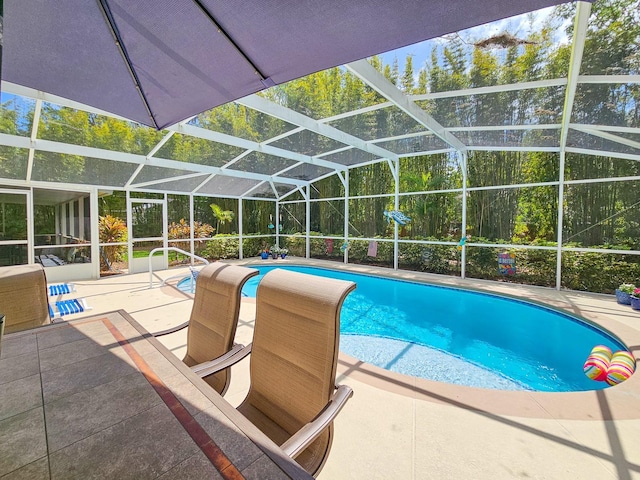 outdoor pool with a patio and glass enclosure