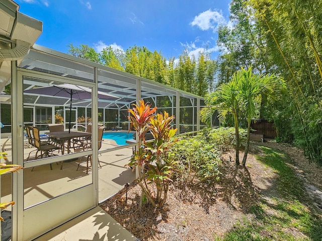 pool featuring fence, a patio, and a lanai