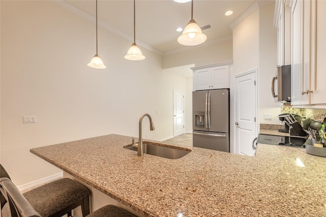 3331 Torre Blvd, New Smyrna Beach, FL 32168 - kitchen featuring crown molding, light stone countertops, appliances with stainless steel finishes, and a sink
