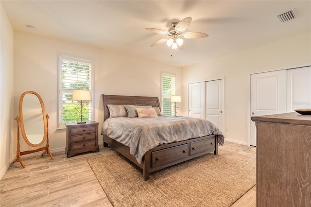 3331 Torre Blvd, New Smyrna Beach, FL 32168 - bedroom with baseboards, multiple closets, multiple windows, and light wood-type flooring