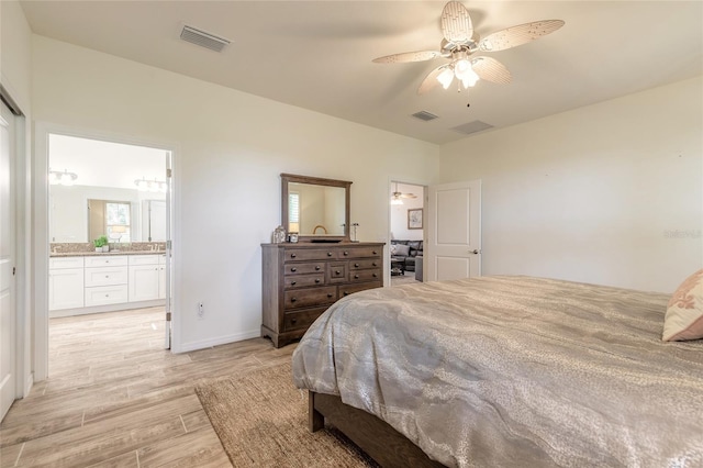 3331 Torre Blvd, New Smyrna Beach, FL 32168 - bedroom with connected bathroom, baseboards, visible vents, and light wood finished floors