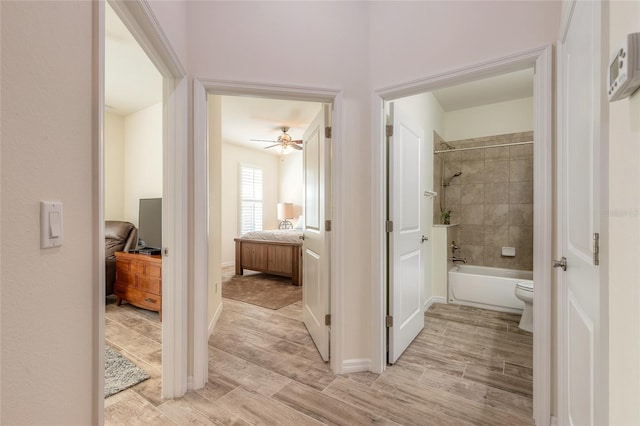 3331 Torre Blvd, New Smyrna Beach, FL 32168 - bathroom featuring ceiling fan, wood finished floors, baseboards, ensuite bath, and tub / shower combination