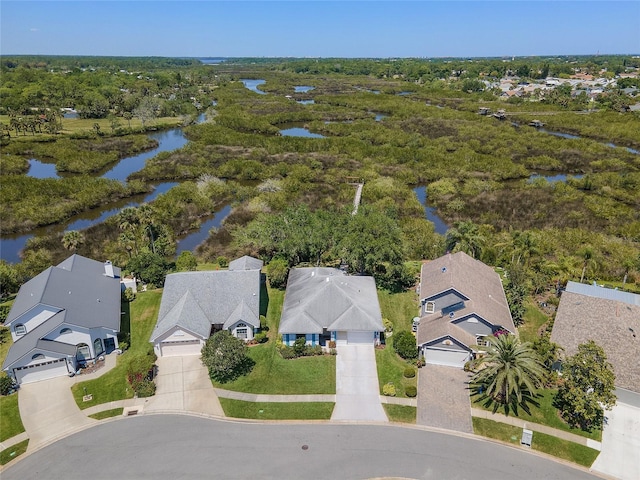 drone / aerial view with a water view and a residential view
