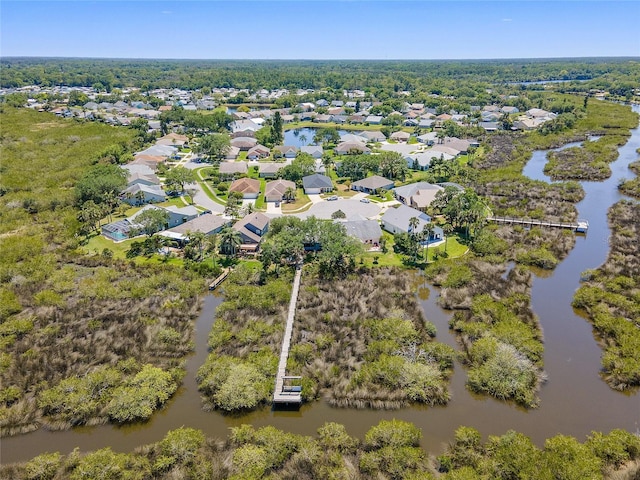 drone / aerial view featuring a water view and a residential view