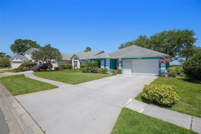 single story home featuring an attached garage, driveway, and a front lawn
