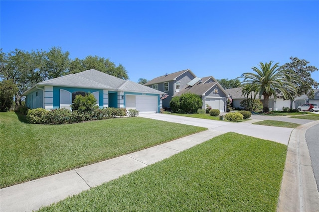 view of front of house with a front yard, a garage, concrete driveway, stucco siding, and a residential view