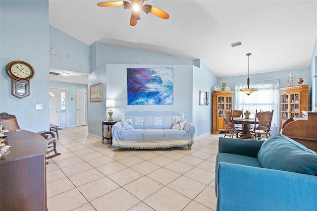 living area featuring vaulted ceiling, light tile patterned floors, ceiling fan, baseboards, and visible vents