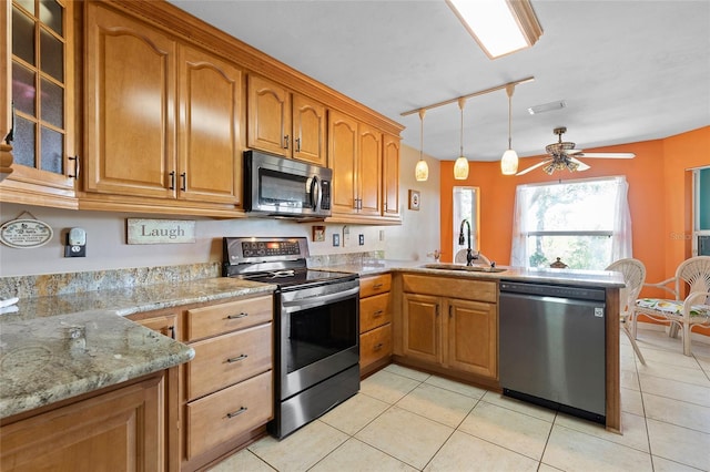 kitchen featuring a sink, light tile patterned flooring, a peninsula, appliances with stainless steel finishes, and visible vents