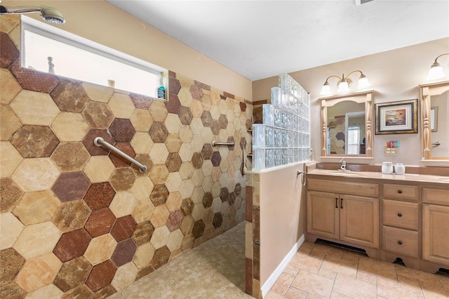 full bath featuring a tile shower and vanity