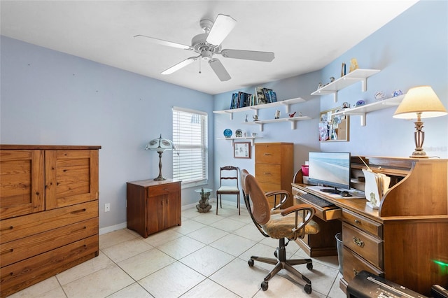 home office featuring baseboards, ceiling fan, and light tile patterned floors