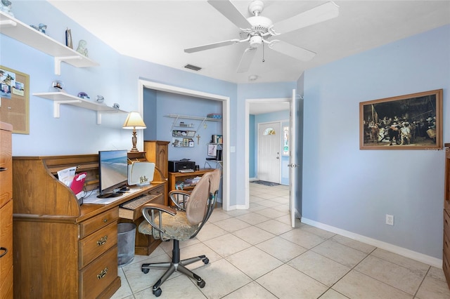 home office with light tile patterned floors, baseboards, visible vents, and ceiling fan