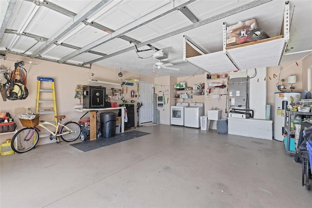 garage featuring washer and clothes dryer, a sink, a garage door opener, and electric water heater