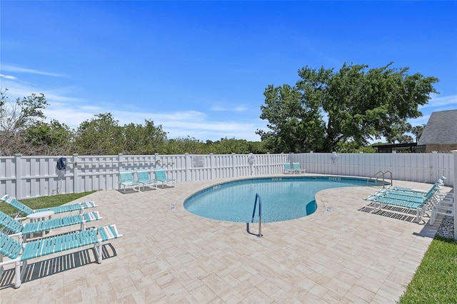 pool featuring fence and a patio