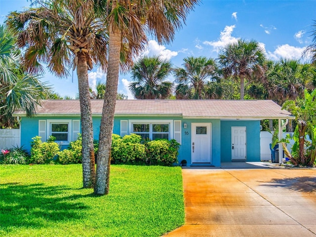 16 Hillside Dr, New Smyrna Beach, FL 32169 - ranch-style house with a front yard, driveway, stucco siding, and fence