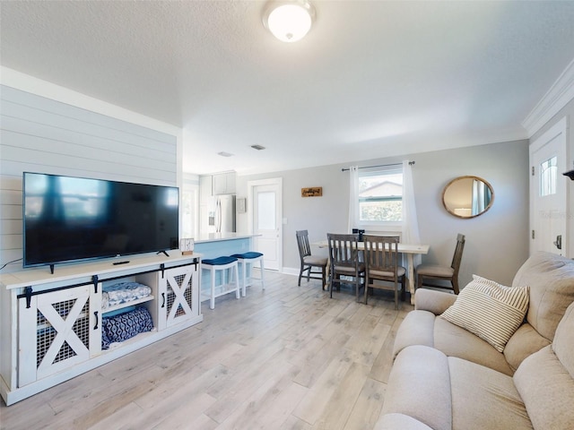 16 Hillside Dr, New Smyrna Beach, FL 32169 - living area with light wood finished floors, a textured ceiling, and ornamental molding