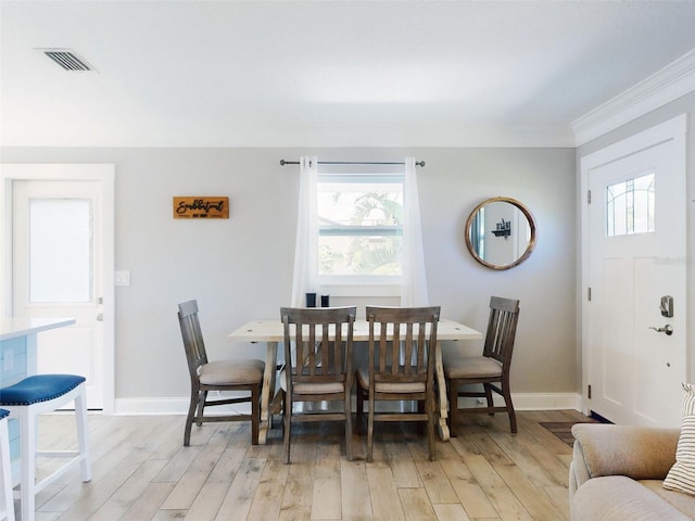 16 Hillside Dr, New Smyrna Beach, FL 32169 - dining space with light wood-style flooring, crown molding, baseboards, and visible vents