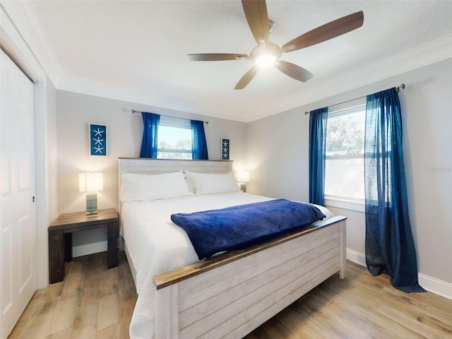 16 Hillside Dr, New Smyrna Beach, FL 32169 - bedroom with crown molding, wood finished floors, baseboards, and a ceiling fan