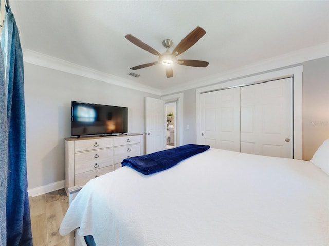 16 Hillside Dr, New Smyrna Beach, FL 32169 - bedroom featuring light wood-style floors, a closet, ornamental molding, visible vents, and baseboards