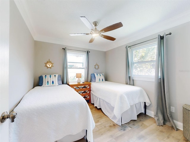 16 Hillside Dr, New Smyrna Beach, FL 32169 - bedroom with ornamental molding, multiple windows, baseboards, and light wood-type flooring