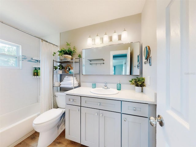 16 Hillside Dr, New Smyrna Beach, FL 32169 - bathroom featuring shower / bath combo with shower curtain, vanity, toilet, and wood finished floors