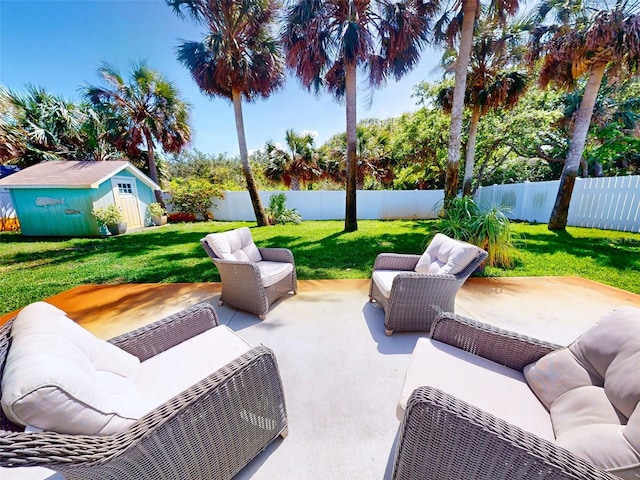 16 Hillside Dr, New Smyrna Beach, FL 32169 - view of patio featuring a storage unit, a fenced backyard, an outdoor structure, and an outdoor hangout area