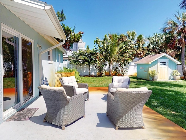 16 Hillside Dr, New Smyrna Beach, FL 32169 - view of patio / terrace with an outbuilding, a fenced backyard, a storage unit, and an outdoor hangout area