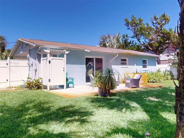 16 Hillside Dr, New Smyrna Beach, FL 32169 - rear view of property featuring fence, a patio, stucco siding, and a pergola