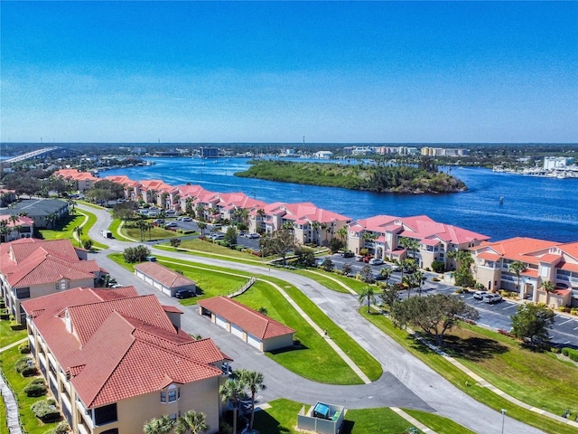 birds eye view of property with a water view and a residential view