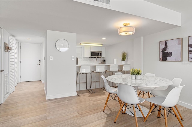 705 N Atlantic Ave Unit 4030, New Smyrna Beach, FL 32169 - dining room featuring recessed lighting, light wood finished floors, and baseboards