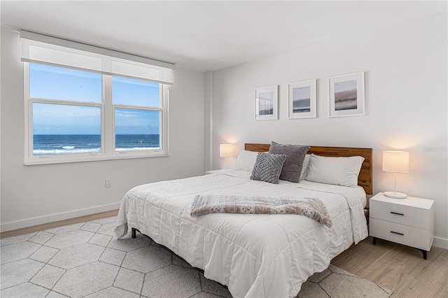 705 N Atlantic Ave Unit 4030, New Smyrna Beach, FL 32169 - bedroom featuring baseboards and light wood finished floors
